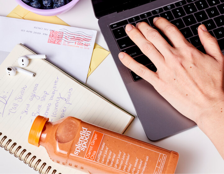 Woman working with Smoothie bottle on her desk