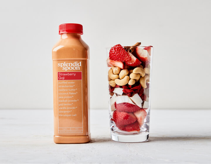 Strawberry Goji Smoothie and glass with raw ingredients