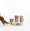 Person eating splendid spoon bowl, with 10 bowls in background Spoon bowls with a Splendid Spoon box