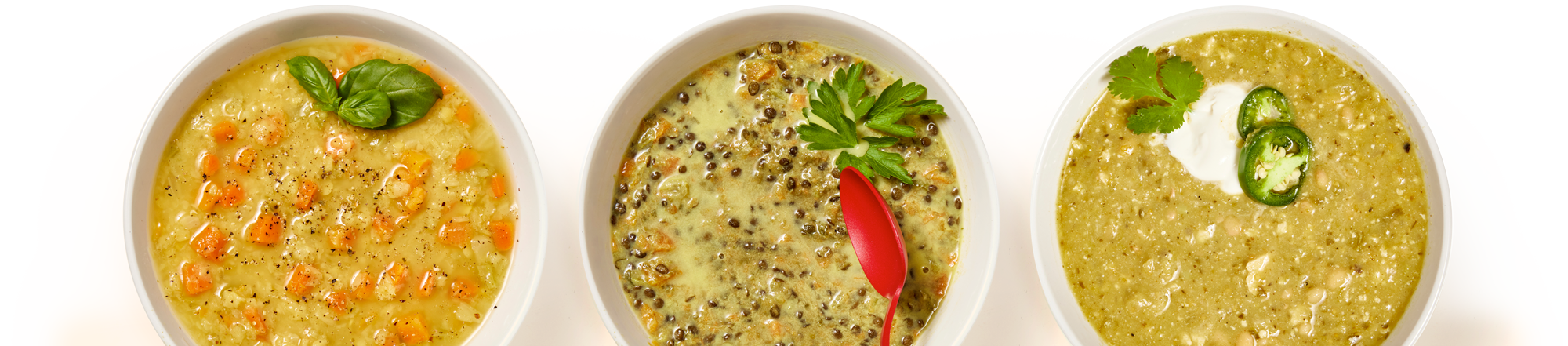 Three bowls of soup seen from directly above.