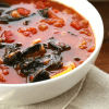 Butternut Squash Ratatouille Soup IN WHITE BOWL ON BEIGE NAPKIN.