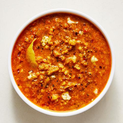 Cauliflower Tikka Soup in a white bowl on a white background