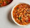 Garden Minestrone Soup in a white bowl next to a pot full of soup