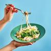 Creamy Mushroom and Spinach Noodles being held up with a fork being pulled up.