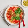 Vegan Meatballs & Marinara Noodles on a table with a napkin and fork and spoon