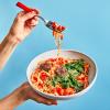 Vegan Meatballs & Marinara Noodles being held in the air with a fork of noodles