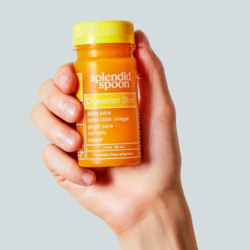 Hand holding a Digestion Shot